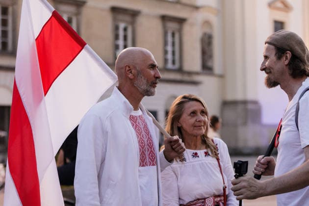 August 9, 2026, Warsaw, Poland: Participants talk to each other during an evening rally marking the sixth anniversary of the August 2020 presidential election in Belarus. An evening gathering marking the sixth anniversary of the August 2020 presidential election in Belarus was held near the Nicolaus Copernicus Monument in central Warsaw, bringing together leaders of Belarusian democratic forces, public figures and activists, as well as several hundred participants. Warsaw Poland - ZUMAs197 20260809_aaa_s197_101 Copyright: xVolhaxShukailax