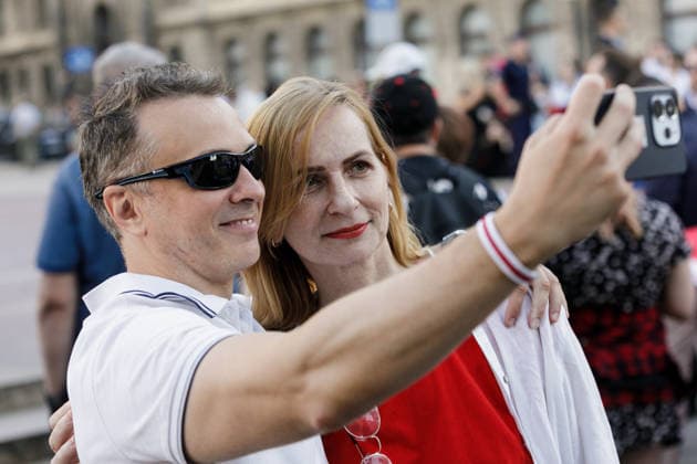 August 9, 2026, Warsaw, Poland: Participants take selfies during an evening rally marking the sixth anniversary of the August 2020 presidential election in Belarus. An evening gathering marking the sixth anniversary of the August 2020 presidential election in Belarus was held near the Nicolaus Copernicus Monument in central Warsaw, bringing together leaders of Belarusian democratic forces, public figures and activists, as well as several hundred participants. Warsaw Poland  - ZUMAs197 20260809_aaa_s197_102 Copyright: xVolhaxShukailax