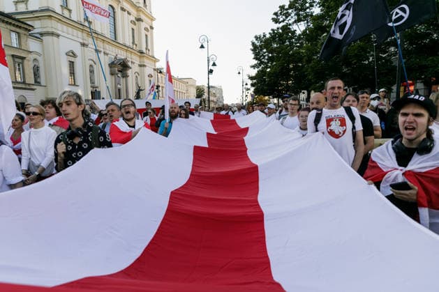 August 9, 2026, Warsaw, Poland: A large white-red-white Belarusian national flag is held by participants during an evening rally marking the sixth anniversary of the August 2020 presidential election in Belarus. An evening gathering marking the sixth anniversary of the August 2020 presidential election in Belarus was held near the Nicolaus Copernicus Monument in central Warsaw, bringing together leaders of Belarusian democratic forces, public figures and activists, as well as several hundred participants. Warsaw Poland  - ZUMAs197 20260809_aaa_s197_111 Copyright: xVolhaxShukailax