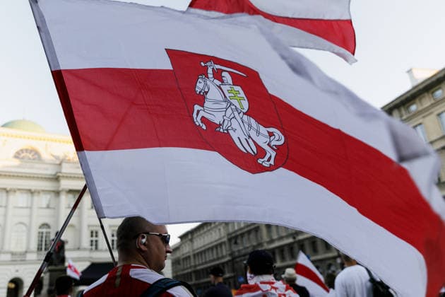 August 9, 2026, Warsaw, Poland: A man holds a Belarusian white-red-white flag during an evening rally marking the sixth anniversary of the August 2020 presidential election in Belarus. An evening gathering marking the sixth anniversary of the August 2020 presidential election in Belarus was held near the Nicolaus Copernicus Monument in central Warsaw, bringing together leaders of Belarusian democratic forces, public figures and activists, as well as several hundred participants. Warsaw Poland - ZUMAs197 20260809_aaa_s197_112 Copyright: xVolhaxShukailax
