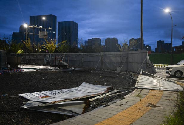 HANGZHOU, CHINA - AUGUST 10: Construction site hoardings are blown down by Typhoon Dolphin on August 10, 2026 in Hangzhou, Zhejiang Province of China. The 13th typhoon of the year brought strong winds and heavy rain to the city, causing damaged facilities, uprooted trees and waterlogged roads.  Copyright: xChinaxNewsxServicex 111659086897