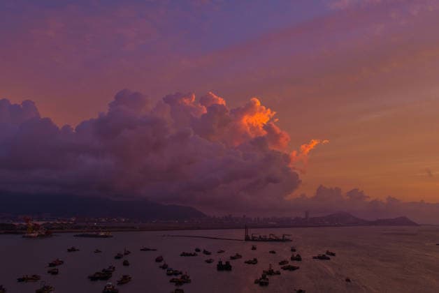 LIANYUNGANG, CHINA - AUGUST 09: Colorful clouds appear in the sky over Lian Island during sunset as Typhoon Dolphin approaches on August 9, 2026 in Lianyungang, Jiangsu Province of China. The typhoon brought significant weather changes to the coastal region.  Copyright: xVCGx 111659074168