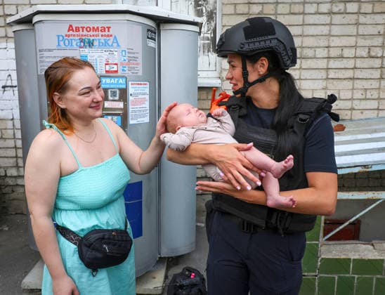 Russian Missile Strikes Apartment Block - Kharkiv A State Emergency Service psychologist holds a baby evacuated from a 10-storey apartment block in the Saltivskyi district hit by a Russian S8000 Banderol cruise missile, Kharkiv, Ukraine, August 9, 2026. As a result of the terrorist attack, the seventh to tenth floors were destroyed. At present, three people are confirmed dead and 37 others injured. Photo by Viacheslav Madiievskyi Ukrinform ABACAPRESS.COM Kharkiv Ukraine  Copyright: xMadiyevskyyxVyacheslav Ukrinformx