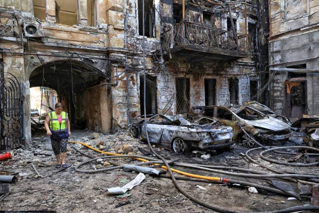 A municipal worker walks among the rubble in the courtyard of a multi-storey apartment block damaged by a Russian attack, Odesa, Ukraine, August 9, 2026. On Sunday night, August 9, the Russian army carried out a massive combined attack on Odesa, causing significant destruction in two districts of the southern Ukrainian port city. In central Odesa, a Russian missile hit a four-storey residential building, where two floors were completely burnt out. Two private houses and offices were also damaged. At least six civilian cars were destroyed or badly damaged in courtyards by falling debris and direct hits. Damage to energy facilities led to a temporary blackout, with partial power outages in the Peresypskyi (Poskot), Prymorskyi, Khadzhybeiskyi  Copyright: xNinaxLiashonokx