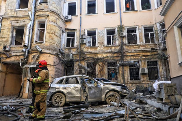 State Emergency Service workers deal with the aftermath of a Russian strike in the courtyard of a multi-storey apartment block, Odesa, Ukraine, August 9, 2026. On Sunday night, August 9, the Russian army carried out a massive combined attack on Odesa, causing significant destruction in two districts of the southern Ukrainian port city. In central Odesa, a Russian missile hit a four-storey residential building, where two floors were completely burnt out. Two private houses and offices were also damaged. At least six civilian cars were destroyed or badly damaged in courtyards by falling debris and direct hits. Damage to energy facilities led to a temporary blackout, with partial power outages in the Peresypskyi (Poskot), Prymorskyi, Khadzhybe  Copyright: xNinaxLiashonokx