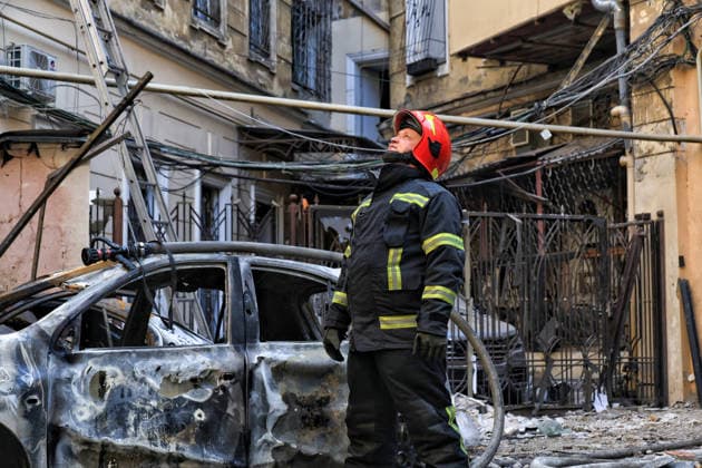 A State Emergency Service worker looks up in the courtyard of a multi-storey apartment block damaged by a Russian attack, Odesa, Ukraine, August 9, 2026. On Sunday night, August 9, the Russian army carried out a massive combined attack on Odesa, causing significant destruction in two districts of the southern Ukrainian port city. In central Odesa, a Russian missile hit a four-storey residential building, where two floors were completely burnt out. Two private houses and offices were also damaged. At least six civilian cars were destroyed or badly damaged in courtyards by falling debris and direct hits. Damage to energy facilities led to a temporary blackout, with partial power outages in the Peresypskyi (Poskot), Prymorskyi, Khadzhybeiskyi  Copyright: xNinaxLiashonokx