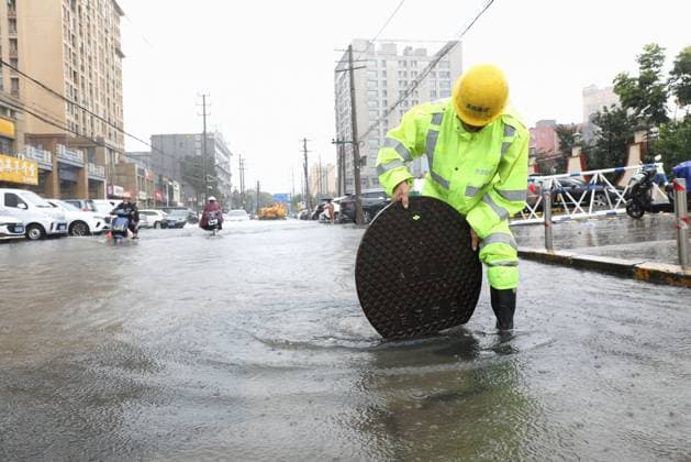 (260810) -- BEIJING, Aug. 10, 2026 -- A rescue worker works on a waterlogged road in Changzhou, east China s Jiangsu Province, Aug. 10, 2026. Typhoon Dolphin is moving inland after making two landfalls along the coast of east China s Zhejiang Province and is expected to bring heavy precipitation to more than 10 provincial-level regions, according to China s National Meteorological Center on Monday. The center issued a blue typhoon warning on Monday morning, forecasting persistent heavy rainfall through Wednesday in regions including Zhejiang, Jiangsu, Henan and Hebei. Some areas are likely to experience torrential rain, thunderstorms and strong winds. Authorities in multiple localities have made all-out efforts in flood prevention an 