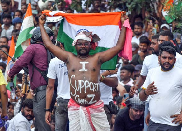 Students march towards Jharkhand Vidhan Sabha against alleged JPSC and JSS CGL paper leak Ranchi, Aug 10 (ANI): A man holding national flag letters his body with I Support Gen Z during students march towards Jharkhand Assembly to protest against the government over alleged JPSC and JSSC-CGL examination paper leak, in Ranchi on Monday. Ranchi Jharkhand India Copyright: xANIx ANI_20260810270
