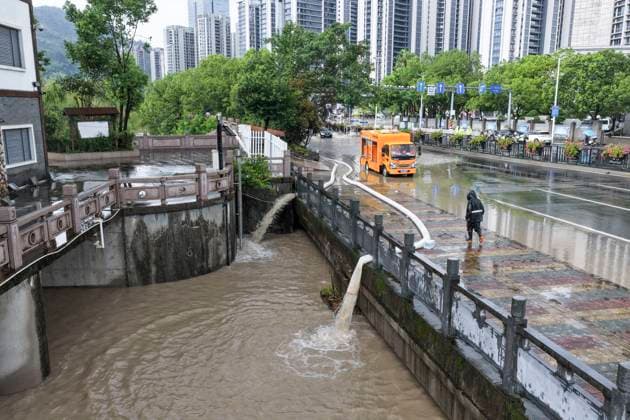 (260810) -- WENZHOU, Aug. 10, 2026 -- A drone photo taken on Aug. 10, 2026 shows high-power pumps draining floodwaters from a street in Shangtang Town in Wenzhou, east China s Zhejiang Province. Typhoon Dolphin is moving inland after making two landfalls along the coast of east China s Zhejiang Province and is expected to bring heavy precipitation to more than 10 provincial-level regions, according to China s National Meteorological Center on Monday. (Photo by Xinhua) CHINA-ZHEJIANG-WENZHOU-TYPHOON DOLPHIN-IMPACT (CN) SuxQiaojiang 