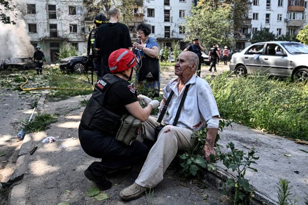 A police paramedic administers first aid to an elderly man injured by a Russian air strike, Zaporizhzhia, Ukraine, August 10, 2026. Russian forces attacked civilian infrastructure in the regional capital and the Zaporizhzhia district with guided aerial bombs. Apartment blocks and private houses were damaged, and cars were wrecked. At least 24 people were injured, including two children. (Photo by Dmytro Smolienko Ukrinform) Russian army attacks Zaporizhzhia with guided bombs again  Copyright: xDmytroxSmolienkox