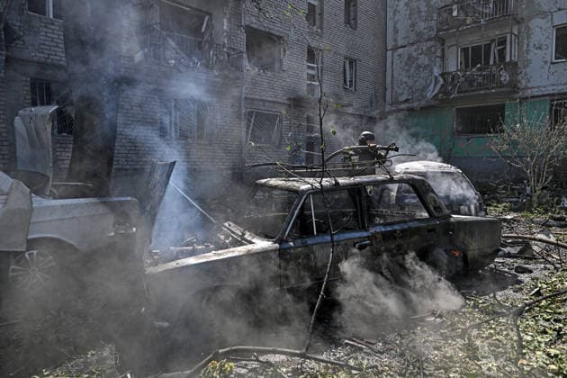 A rescuer extinguishes a fire in a car destroyed by a Russian air strike, Zaporizhzhia, Ukraine, August 10, 2026. Russian forces attacked civilian infrastructure in the regional capital and the Zaporizhzhia district with guided aerial bombs. Apartment blocks and private houses were damaged, and cars were wrecked. At least 24 people were injured, including two children. (Photo by Dmytro Smolienko Ukrinform) Russian army attacks Zaporizhzhia with guided bombs again  Copyright: xDmytroxSmolienkox