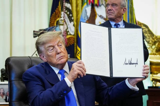President Donald Trump holds up an executive order that reevaluates childhood vaccines in the Oval Office of the White House in Washington, DC on August 10, 2026. While the executive order still recommends childhood vaccines for 11 diseases, including measles and polio, it calls for limiting vaccines for other diseases, like hepatitis A and B and meningococcal disease, to high-risk populations.  WAP20260810112 BONNIExCASH