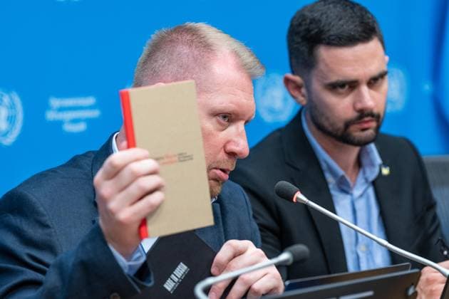 August 10, 2026, New York, New York, USA: Oleg Gushchyn, Legal Counsellor, Coordination Headquarters for the Treatment of Prisoners of War of Ukraine speaks while holding a book about treatment of Ukrainian POW by Russian authorities during press briefing organized by Permanent Mission of Ukraine at UN Headquarters in New York, NY on August 10, 2026. Khuan Leyva Garsiya and Leniie Umerova briefed press on their experience being in captivity in Russia and their witness of treatments by Russian authorities of POW and civilians taken into prisons in Russia. New York USA  - ZUMAr339 20260810_znp_r339_009 Copyright: xLevxRadinx