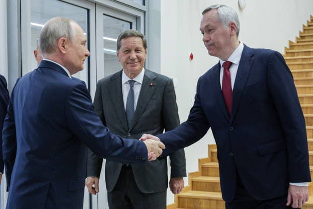 RUSSIA, NOVOSIBIRSK - AUGUST 11, 2026: Russia s President Vladimir Putin, Russian State Duma s First Deputy Speaker Alexander Zhukov, and Novosibirsk Region Governor Andrei Travnikov (L-R) visit the Specialised Educational Scientific Centre of Novosibirsk State University. Gavriil Grigorov Russian Presidential Press and Information Office TASS  96025205
