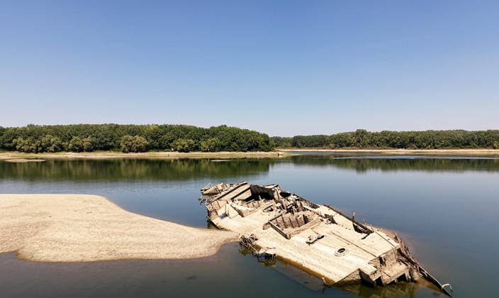 World War II-German warships emerge from Danube amid low water levels in Serbia PRAHOVO, SERBIA - AUGUST 11: Sunken hulls of World War II-era Nazi warships lie exposed in the Danube River near Prahovo, Serbia on August 11, 2026. Extreme heat and severe drought across Europe have caused water levels in the river to drop to historic lows, revealing dozens of scuttled German vessels laden with explosives from 1944. According to some estimates, around 200 World War II shipwrecks lie on the sandy bed of the Danube. Sasa Djordjevic Anadolu Prahovo Serbia. Editorial use only. Please get in touch for any other usage.  Copyright: x2026xAnadoluxSasaxDjordjevicx