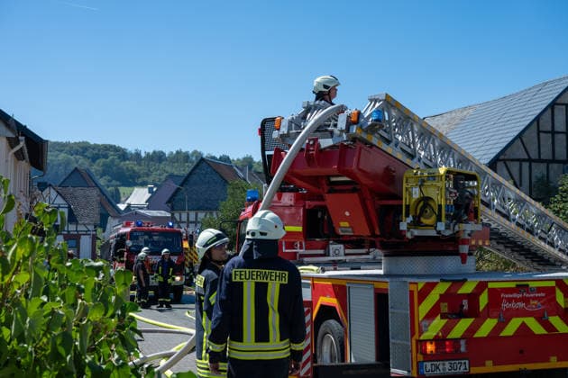 Ehemalige Gaststätte, Lagerhalle und Garage stehen in Vollbrand Am 11.08.2026 brannten in Greifenstein-Arborn das Gebäude einer ehemaligen Gaststätte, eine Lagerhalle und eine benachbarte Garage. Die Einsatzkräfte waren zunächst zu einer brennenden Gartenhütte alarmiert worden, das Einsatzstichwort wurde noch auf der Anfahrt auf einen Wohnhausbrand erhöht. Beim Eintreffen der Feuerwehr standen die Gebäude teils bereits in Vollbrand, verletzt wurde niemand. Die L3046 K91 war im betroffenen Bereich aufgrund des Einsatzes gesperrt. Rund 140 Einsatzkräfte waren im Einsatz, unterstützt von den Drehleitern aus Herborn und Weilburg sowie weiteren Kräften umliegender Feuerwehren, dem THW und der Polizei. Greifenborn Arborn Hessen Deutsch