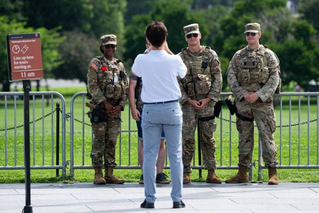 National Guard in DC Anniversary UNITED STATES - AUGUST 11: National Guard troops pose for photos with tourists at the base of the Washington Monument on Aug. 11, 2026, in Washington. The National Guard was mobilized to DC a year ago on Aug. 11, 2025. (Bill Clark CQ Roll Call) Washington DC United States EDITORIAL USE ONLY Copyright: x 2026xCQxRollxCallx BillxClarkx rollcallpix172451