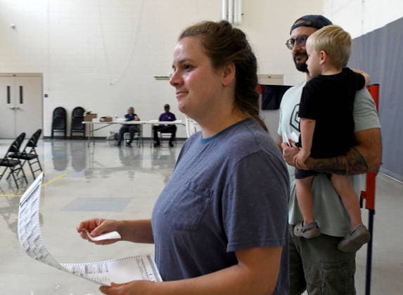 August 11, 2026, Racine, Wisconsin, USA: ALEXANDRIA and TYLER SCHEER, with their son CALLAHAN, 2, vote at Fratt Elementary School in Racine in the Wisconsin primary election Tuesday August 11, 2026. National focus is on the Democratic gubernatorial primary and on efforts to flip several Republican congressional seats, including that of incumbent Bryan Steil who represents the First Congressional District, including Racine County. Racine USA  - ZUMAh154 20260811_znp_h154_013 Copyright: xMarkxHertzbergx