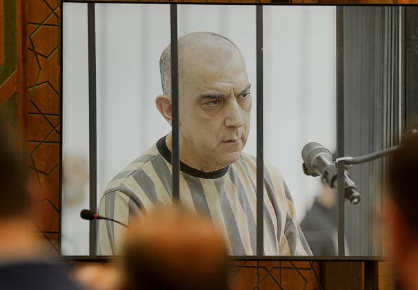 (260812) -- DAMASCUS , Aug. 12, 2026 -- Syrian former senior security official Atef Najib is seen on a courtroom screen during a court session in Damascus, Syria, Aug. 11, 2026. The Fourth Criminal Court in Damascus on Tuesday sentenced Najib to death over killings and abuses linked to the Syrian conflict, according to reports on the court proceedings. (Photo by Xinhua) SYRIA-DAMASCUS-FORMER SENIOR SECURITY OFFICIAL-SENTENCE AmmarxSafarjalani 