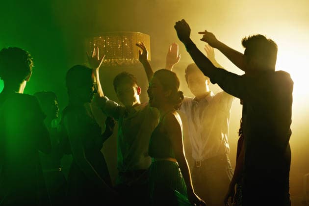 Happy, people and friends dancing at nightclub with energy, movement and rhythm at disco event. Group, laugh and reunion for New Years celebration, music festival and freedom or bonding for nightlife. model released property released Copyright: xx