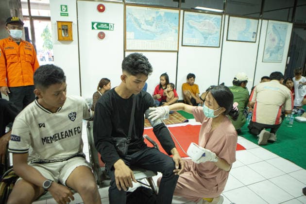 August 12, 2026, Karangasem, Bali, Indonesia: Passengers of the ferry KMP Putri Yasmin await data collection and medical examinations at the ASDP Emergency Post in Padangbai Port, Karangasem, Bali. ...A navy vessel and surrounding ships rushed to rescue 131 people onboard (114 passengers and 17 crew members) after the inter-island ferry caught fire in the Sekotong waters of the Lombok Strait at around 4:15 AM local time during its voyage to Lembar, Lombok. Authorities confirmed 35 survivors were evacuated back to Padangbai, while the remaining were transported to Lombok. One casualty was reported in the incident. Karangasem Indonesia - ZUMAp229 20260812_zip_p229_002 Copyright: xLanaxPriatnax