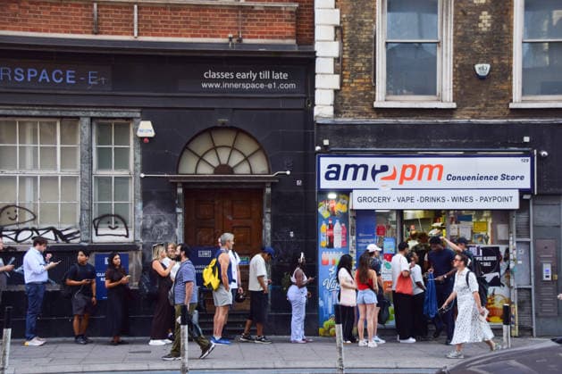 August 12, 2026, London, England, United Kingdom: A long queue forms outside the AM2PM convenience store on Whitechapel High Street in London as people try to snag last-minute solar eclipse glasses ahead of the partial eclipse this evening. London United Kingdom - ZUMAv130 20260812_zip_v130_007 Copyright: xVukxValcicx