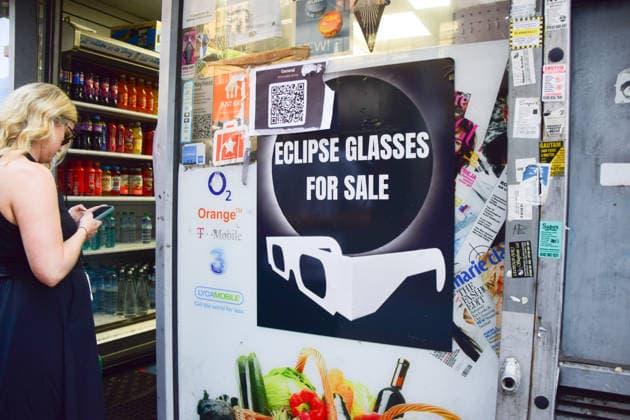 August 12, 2026, London, England, United Kingdom: A long queue forms outside the AM2PM convenience store on Whitechapel High Street in London as people try to snag last-minute solar eclipse glasses ahead of the partial eclipse this evening. London United Kingdom  - ZUMAv130 20260812_zip_v130_014 Copyright: xVukxValcicx