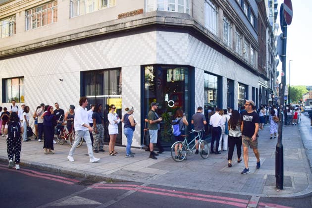 August 12, 2026, London, England, United Kingdom: A long queue forms outside the AM2PM convenience store on Whitechapel High Street in London as people try to snag last-minute solar eclipse glasses ahead of the partial eclipse this evening. London United Kingdom - ZUMAv130 20260812_zip_v130_016 Copyright: xVukxValcicx