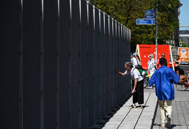 65th Anniversary of the Berlin Wall in Berlin BERLIN, GERMANY – AUGUST 12: People visit the opening ceremony of a 30-meter-long temporary memorial installation and the open-air exhibition Views of the Wall: Berlin 1961–1990, marking the 65th anniversary of the construction of the Berlin Wall, near the Brandenburg Gate in Berlin, Germany, on August 12, 2026. Volodymyr Sindieiev Anadolu Berlin Germany. Editorial use only. Please get in touch for any other usage.  Copyright: x2026xAnadoluxVolodymyrxSindieievx