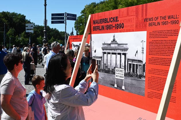 65th Anniversary of the Berlin Wall in Berlin BERLIN, GERMANY – AUGUST 12: People visit the opening ceremony of a 30-meter-long temporary memorial installation and the open-air exhibition Views of the Wall: Berlin 1961–1990, marking the 65th anniversary of the construction of the Berlin Wall, near the Brandenburg Gate in Berlin, Germany, on August 12, 2026. Volodymyr Sindieiev Anadolu Berlin Germany. Editorial use only. Please get in touch for any other usage.  Copyright: x2026xAnadoluxVolodymyrxSindieievx