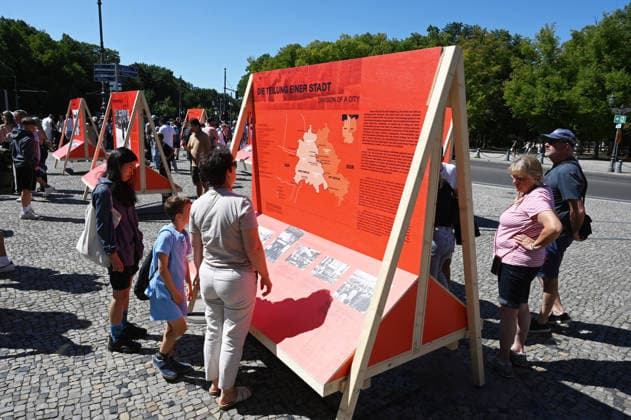 65th Anniversary of the Berlin Wall in Berlin BERLIN, GERMANY – AUGUST 12: People visit the opening ceremony of a 30-meter-long temporary memorial installation and the open-air exhibition Views of the Wall: Berlin 1961–1990, marking the 65th anniversary of the construction of the Berlin Wall, near the Brandenburg Gate in Berlin, Germany, on August 12, 2026. Volodymyr Sindieiev Anadolu Berlin Germany. Editorial use only. Please get in touch for any other usage.  Copyright: x2026xAnadoluxVolodymyrxSindieievx