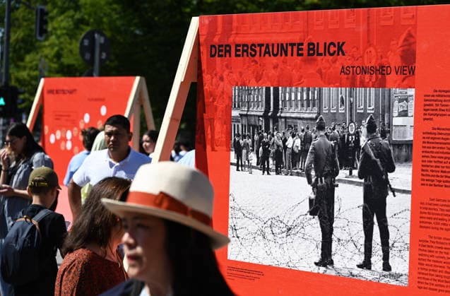 65th Anniversary of the Berlin Wall in Berlin BERLIN, GERMANY – AUGUST 12: People visit the opening ceremony of a 30-meter-long temporary memorial installation and the open-air exhibition Views of the Wall: Berlin 1961–1990, marking the 65th anniversary of the construction of the Berlin Wall, near the Brandenburg Gate in Berlin, Germany, on August 12, 2026. Volodymyr Sindieiev Anadolu Berlin Germany. Editorial use only. Please get in touch for any other usage.  Copyright: x2026xAnadoluxVolodymyrxSindieievx