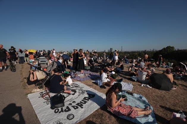 . 12 08 2026. London, United Kingdom. Partial Solar Eclipse. People gather on Primrose Hill in London to observe a Partial Solar Eclipse.  xMartynxWheatleyx xi-Imagesx IIM-26943-0012