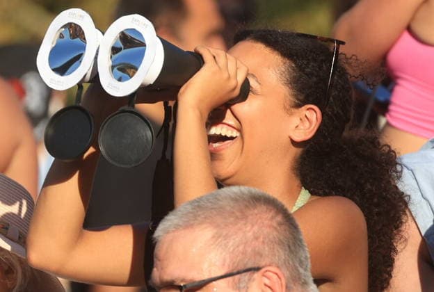 August 12, 2026, London, London, UK: London, UK. People wearing protective glasses watch a solar eclipse in Greenwich as the Moon passes in front of the Sun and blocks its light. In London, more than 90% of the Sun is covered at the peak of the eclipse. The eclipse takes place across the UK from 18:17 to 20:06, reaching its maximum at 19:12. London UK  - ZUMAl94_ 20260812_zaf_l94_030 Copyright: xMarcinxNowakx