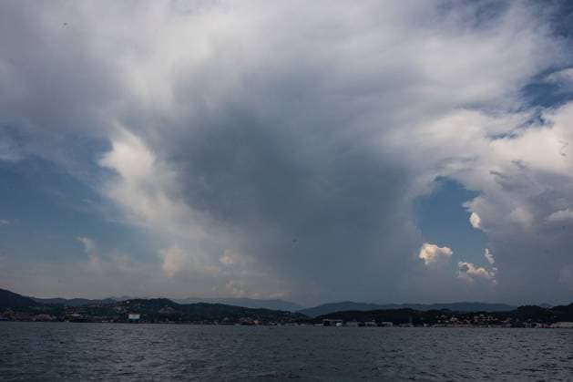 August 12, 2026, La Spezia, Italy: LA SPEZIA, ITALY Ã¢â‚¬ AUGUST 12, 2026: A towering cumulonimbus cloud rises over the Gulf of La Spezia on August 12, 2026, hours after a magnitude 3.7 earthquake struck off the northern Tuscan coast. Boats navigate the Gulf of La Spezia as dramatic storm clouds build over the Ligurian coast on August 12, 2026. Earlier in the day, a magnitude 3.7 earthquake struck off the northern Tuscan coast at 10:57 a.m. local time at a depth of about 9 kilometres, shaking parts of Liguria and Tuscany, including La Spezia, with no damage or injuries reported. Residents and visitors later gathered along the coast to observe a partial solar eclipse visible shortly before sunset. La Spezia Italy - ZUMAq101 20260812_zna_q101_181 Copyright: xGianxMarcoxBenedettox