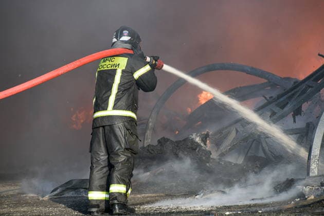 RUSSIA, KRASNODAR REGION - AUGUST 12, 2026: An employee of the Russian Emergencies Minsitry extinguishes a fire at a warehouse storing plastic products in the village of Lenina, southeast of Krasnodar. The fire covering an area of 2.2 thousand sq m has been contained Russia  - ZUMAt113 20260812_zaa_t113_360 Copyright: xRomanxSokolovx