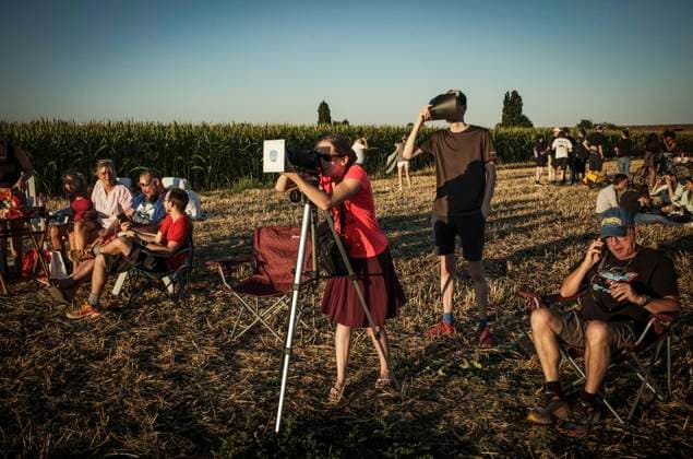 August 12, 2026: People observe the partial solar eclipse using eclipse glasses, improvised viewing devices and telescopes at several locations in Brussels, Belgium, Wednesday, 12.08.2026. The partial eclipse was visible across Belgium during the evening, drawing residents and amateur astronomers to open spaces to watch the phenomenon. - ZUMAw80_ 20260812_faf_w80_005 Copyright: xWiktorxDabkowskix