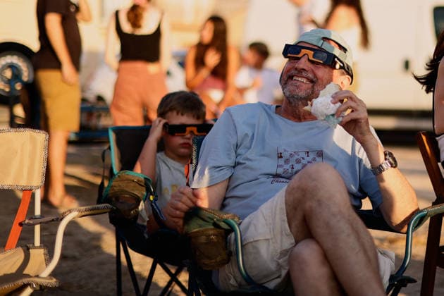 The Perfect Alignment Of The Moon And The Sun During The Total Solar Eclipse Of 2026 Tourists and outdoor enthusiasts wearing protective eyewear look at the solar corona during totality in Horta de Sant Joan, Spain, on August 12, 2026. The solar corona is visible over the mountain peaks of Els Ports Natural Park during the total solar eclipse. Horta de Sant Joan Catalonia Spain  Copyright: xJoanxCrosx originalFilename: cros-notitle260812_nppMN.jpg