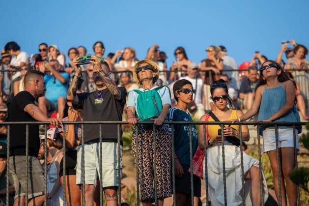 August 12, 2026, Madrid, Spain: People wearing eclipse glasses observe the sky during the solar eclipse in Madrid. Madrid Spain - ZUMAs197 20260812_aaa_s197_163 Copyright: xDavidxCanalesx