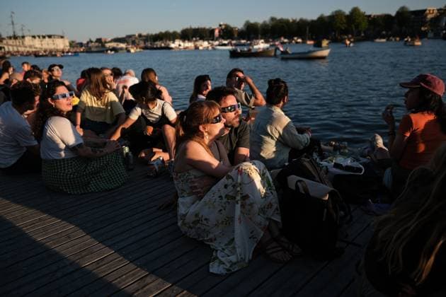 Amsterdam Watches Near-Total Solar Eclipse People watch a partial solar eclipse in Amsterdam, Netherlands, on August 12, 2026. The Moon obscures about 88% of the Sun during the near-total eclipse, which is visible from across the Netherlands but falls outside the path of totality. The country last saw a near-total eclipse in 1999, while a partial eclipse was visible in 2015. The next total solar eclipse visible from the Netherlands will take place on October 7, 2135. Amsterdam Netherlands  Copyright: xGeorgiosxKostomitsopoulosx originalFilename: kostomitsopoulos-amsterda260812_npLsb.jpg