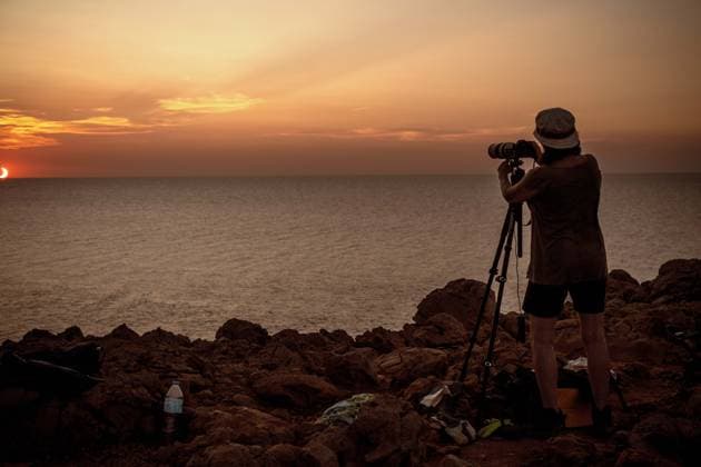 August 12, 2026, Ciutadella, Balearic Islands Menorca, Spain: A photographer takes pictures of a total solar eclipse from the rocky coast at Punta Nati on the Spanish Balearic island of Menorca. Ciutadella Spain - ZUMAo105 20260812_fap_o105_026 Copyright: xMatthiasxOesterlex