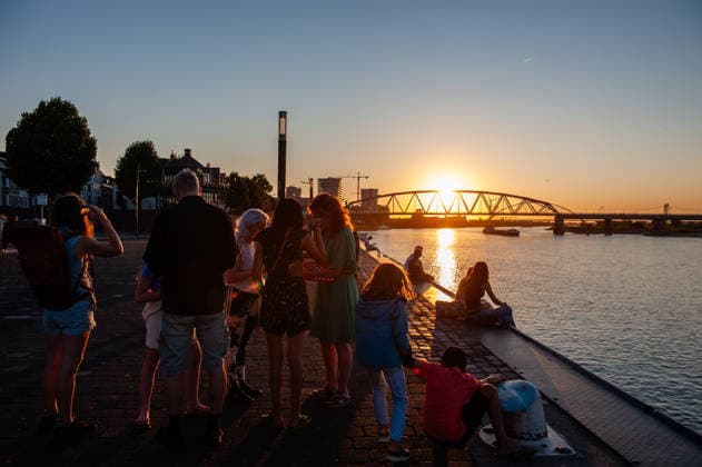 August 12, 2026, Nijmegen, Netherlands: A family is enjoying the last remnants of the partial solar eclipse. On the banks of the Waal River in Nijmegen, people gathered to watch the partial solar eclipse. The solar eclipse began at 7:16 PM, with 88% of the sun eclipsed by 8:11 PM. This is the largest partial solar eclipse the Netherlands has seen since 1999; the next one of this magnitude will be in 2081. Nijmegen Netherlands - ZUMAs197 20260812_aaa_s197_183 Copyright: xAnaxFernandezx