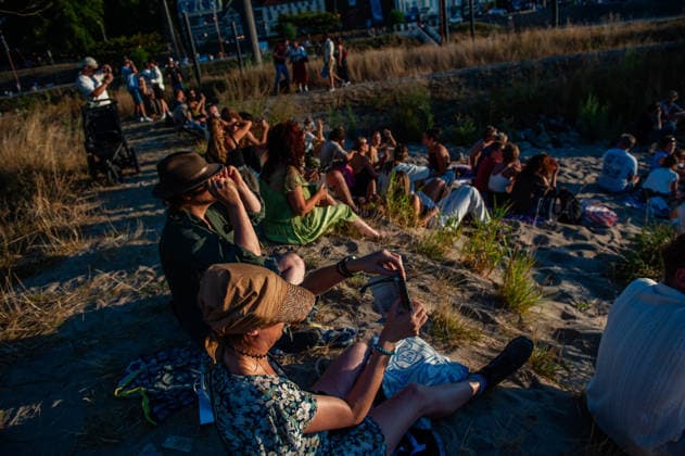 August 12, 2026, Nijmegen, Netherlands: People are trying to take photos of the partial eclipse with their mobile phones. On the banks of the Waal River in Nijmegen, people gathered to watch the partial solar eclipse. The solar eclipse began at 7:16 PM, with 88% of the sun eclipsed by 8:11 PM. This is the largest partial solar eclipse the Netherlands has seen since 1999; the next one of this magnitude will be in 2081. Nijmegen Netherlands - ZUMAs197 20260812_aaa_s197_193 Copyright: xAnaxFernandezx
