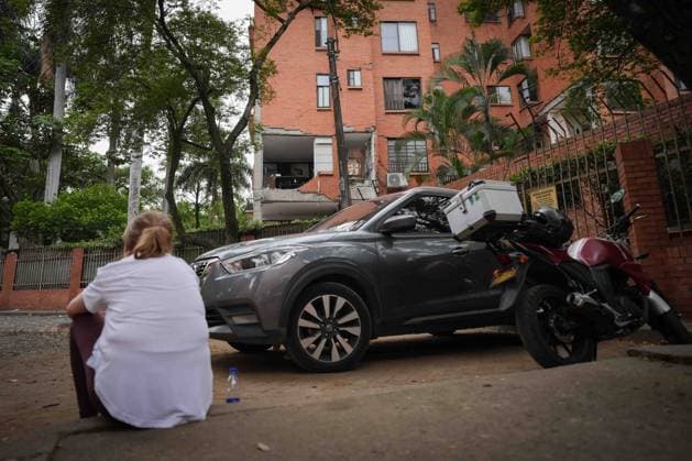 (260812) -- CALI, Aug. 12, 2026 -- A women sits outside of a damaged building in an earthquake in Cali, Colombia on Aug. 12, 2026. The death toll from Monday s 7.4-magnitude earthquake in western Colombia has risen to 241, with 3,771 others injured, Colombian media reported Wednesday, citing figures from the National Unit for Disaster Risk Management. (Photo by Xinhua) COLOMBIA-CALI-EARTHQUAKE-AFTERMATH AndresxMoreno 