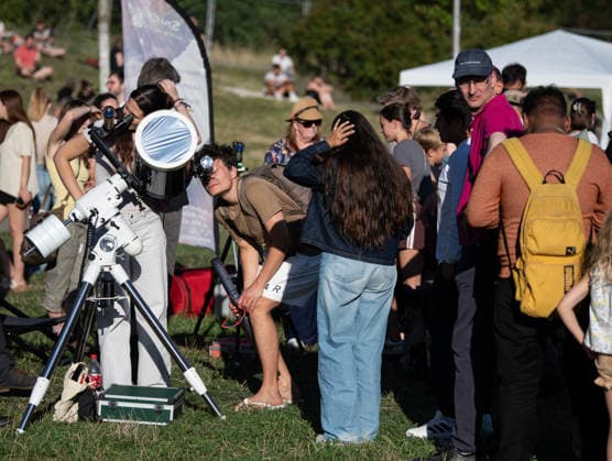 (260812) -- BERLIN, Aug. 12, 2026 -- People queue up to try out the observation equipment at the Zeiss Grand Planetarium in Berlin, Germany, Aug. 12, 2026. The Long Night of Astronomy event was held here on Wednesday, inviting the public to observe the solar eclipse and experience the fascination of astronomy. ) GERMANY-BERLIN-SOLAR ECLIPSE ZhangxHaofu 
