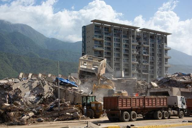 Recovery Efforts Continue in Earthquake-Ravaged La Guaira LA GUAIRA, VENEZUELA AUGUST 12, 2026: Residents continue moving through earthquake-damaged neighborhoods in Tanaguarena, Los Corales and Catia La Mar, where destroyed roads, collapsed buildings and debris continue to disrupt daily life 49 days after the twin earthquakes struck Venezuela s central coast. With public transportation limited, residents walk through rubble and around heavy machinery to reach different parts of the affected areas, while many continue searching for drinking water as recovery and debris removal operations remain underway. Estado la guaira Venezuela (Bolivarian Republic of) Copyright: x xFranyerxNievesx(Babel)x xJNAxPressx