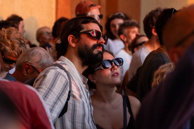 IPA87432113 - Spectators wear protective eclipse glasses to safely watch a solar eclipse at the Sanctuary of the Madonna di San Luca. Bologna, Italy, August 8, 2026  Copyright: xLeonardoxGaravaglia LiveMediax xx 87432113