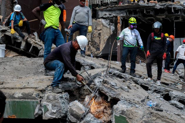 August 12, 2026, Cali, Valle Del Cauca, Colombia: People gather outside collapsed buildings in Cali, Colombia on August 12, 2026 to aid in several rescue labors after a 7,4 magnitude earthquake that struck the cities of Quibdo, Cali, Pereira and Manizales leaving more than 200 casualties past august 10. Cali Colombia - ZUMAvp1_ 20260812_zia_vp1_004 Copyright: xMartinxStevenxAngelx