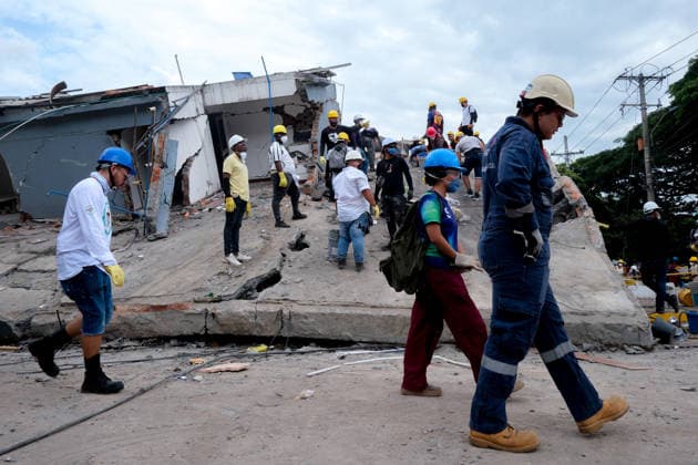 August 12, 2026, Cali, Valle Del Cauca, Colombia: People gather outside collapsed buildings in Cali, Colombia on August 12, 2026 to aid in several rescue labors after a 7,4 magnitude earthquake that struck the cities of Quibdo, Cali, Pereira and Manizales leaving more than 200 casualties past august 10. Cali Colombia - ZUMAvp1_ 20260812_zia_vp1_009 Copyright: xMartinxStevenxAngelx