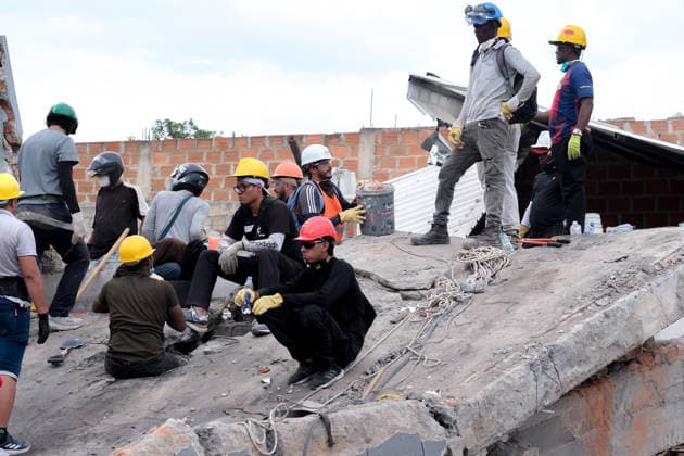 August 12, 2026, Cali, Valle Del Cauca, Colombia: People gather outside collapsed buildings in Cali, Colombia on August 12, 2026 to aid in several rescue labors after a 7,4 magnitude earthquake that struck the cities of Quibdo, Cali, Pereira and Manizales leaving more than 200 casualties past august 10. Cali Colombia - ZUMAvp1_ 20260812_zia_vp1_013 Copyright: xMartinxStevenxAngelx